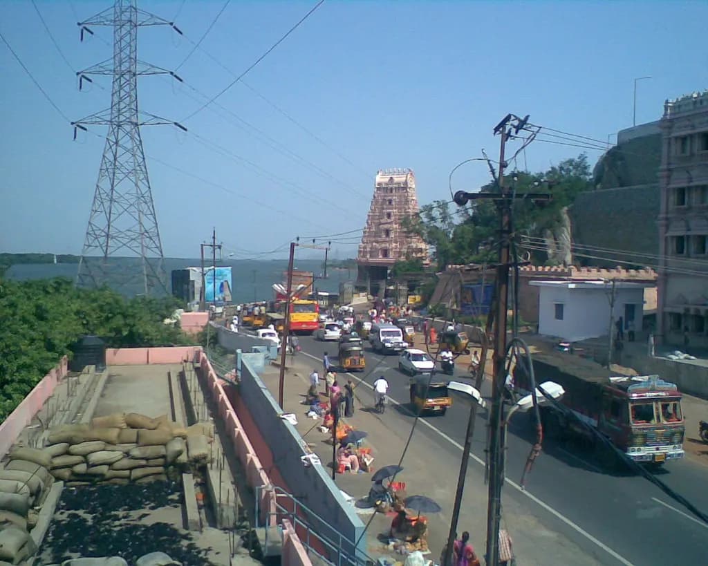 A busy street with shops and traffic in Vijayawada, Andhra Pradesh
