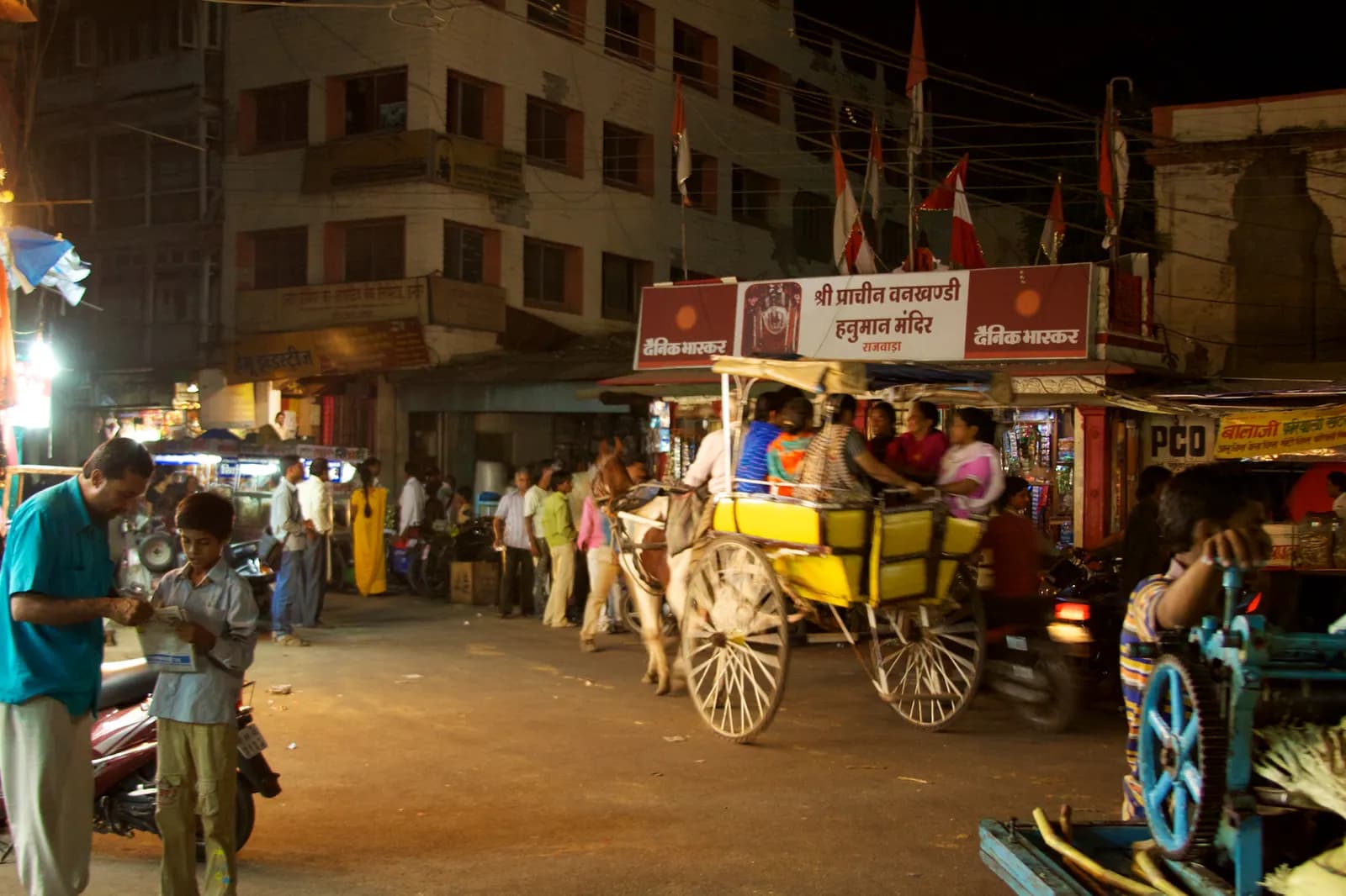 Evening traffic of cars, scooters and auto-rickshaws on a busy road in Indore