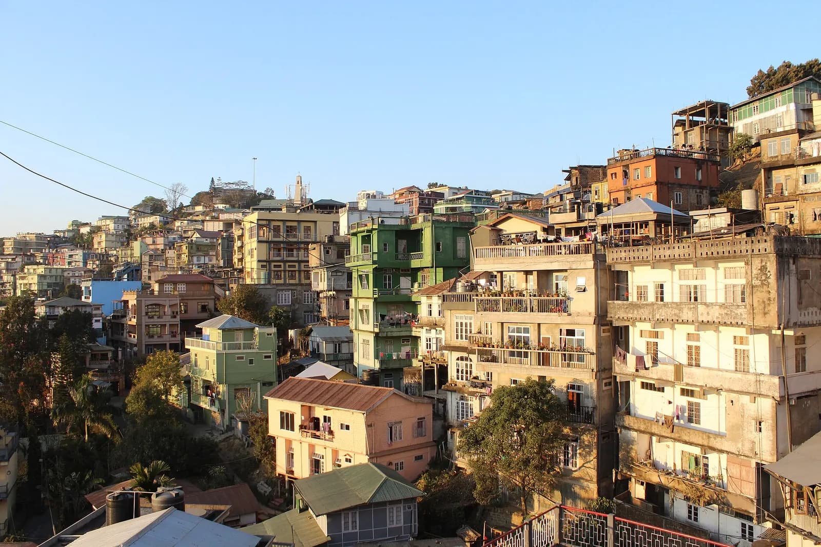 Multi-storey buildings stacked on a steep hillside in Aizawl, Mizoram
