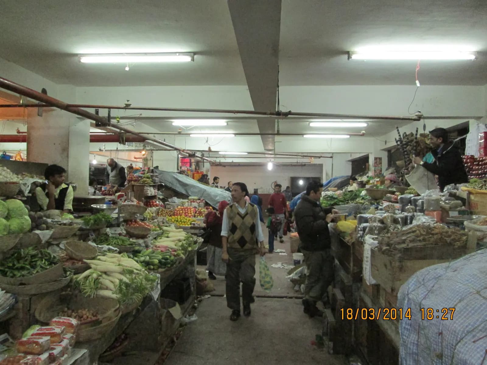 Vendors and shoppers among vegetable stalls inside Lal Bazaar market in Gangtok