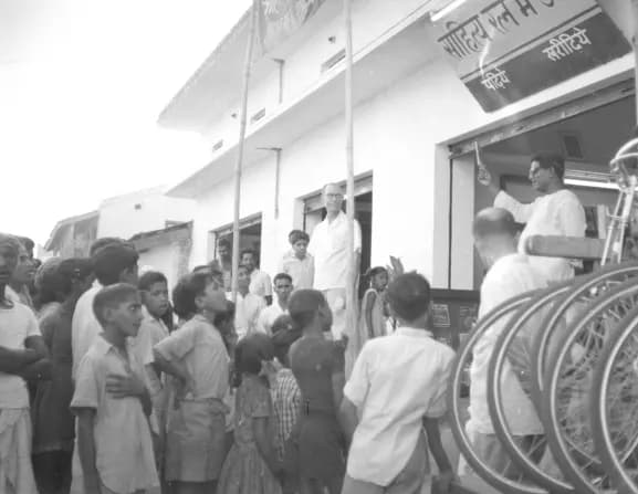 Black-and-white photograph of a crowd outside a newly opened bookstore in Dhamtari in 1965
