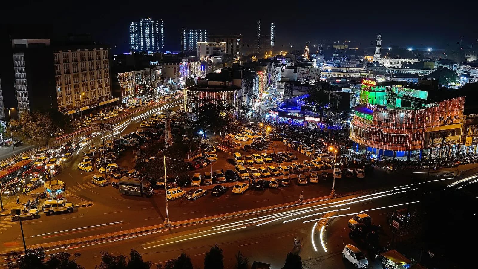 Bhopal's New Market lit up at night during Diwali, seen from above with crowds and shops
