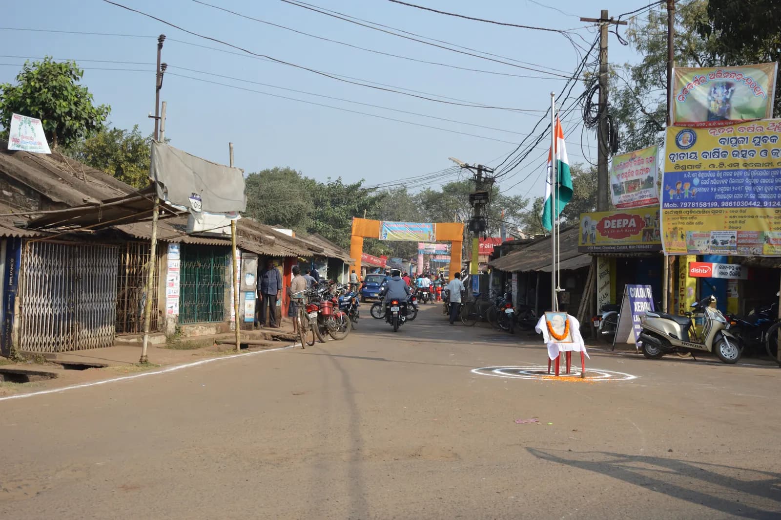 A street of small shops in the OTM Bazaar area of Choudwar, Cuttack district, on a sunny morning