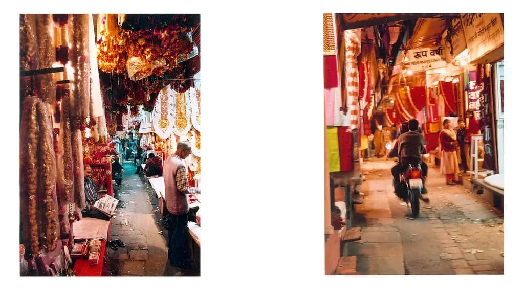 A narrow bazaar lane in Jaipur lined with small shops selling textiles and household goods