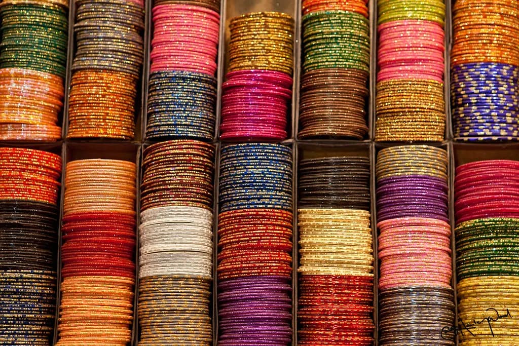 Rows of colourful glass bangles stacked in the display boxes of a bangle shop in Varanasi