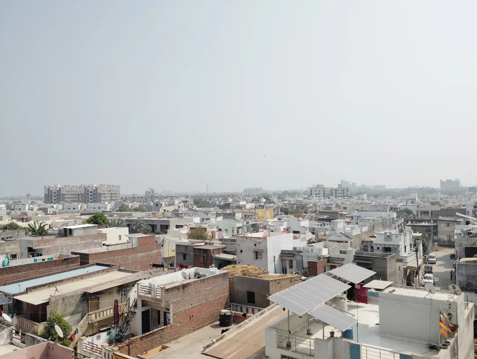 Solar panels mounted on the flat rooftops of houses in Mehsana, Gujarat