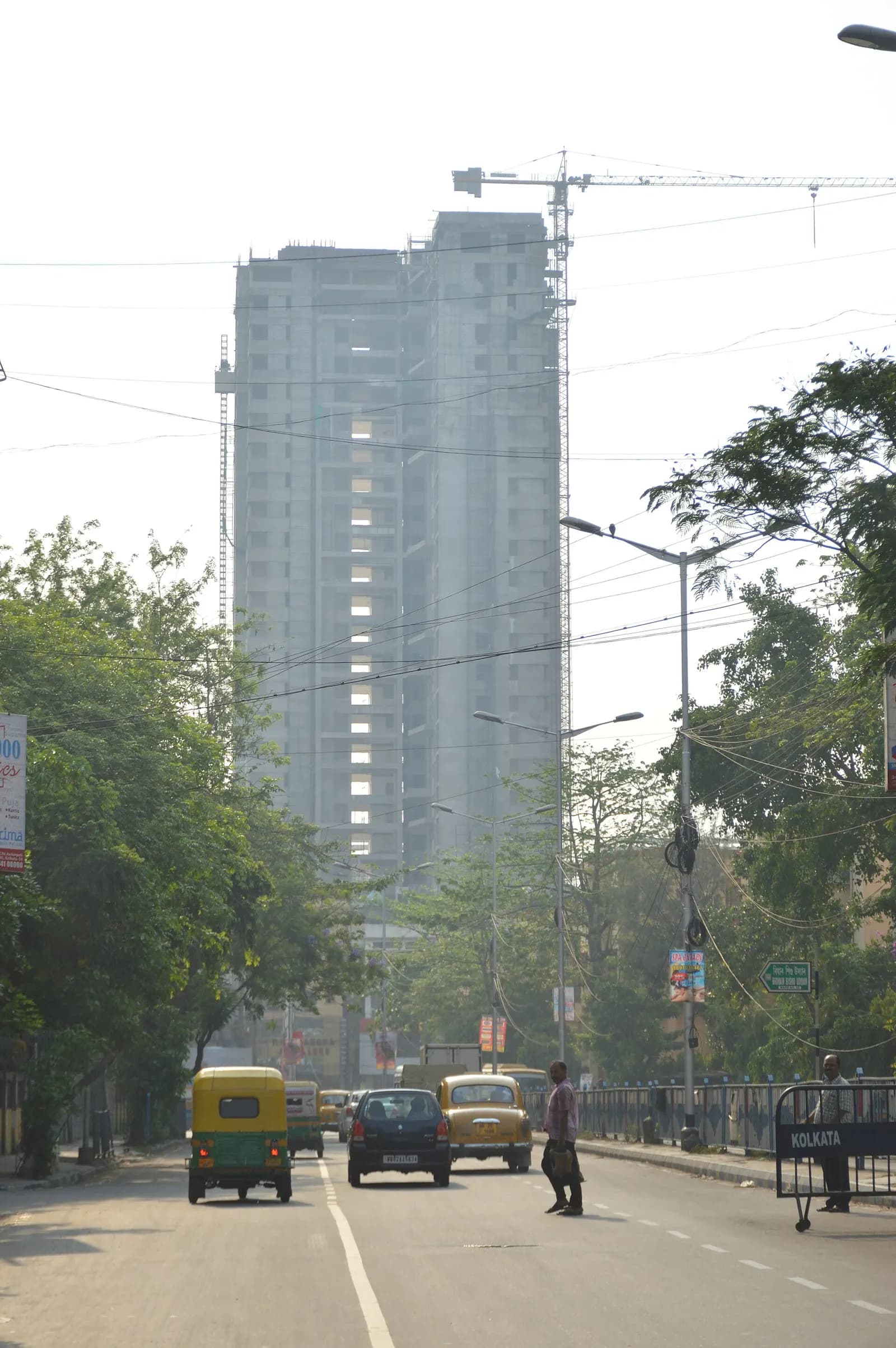 A residential high-rise under construction beside a main road in Ultadanga, Kolkata