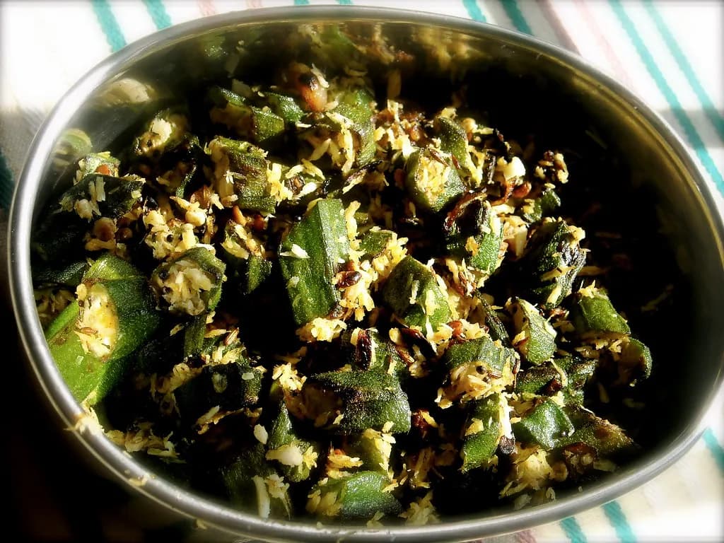 Bhindi poriyal, okra stir-fried with grated coconut, packed in a stainless steel tiffin container