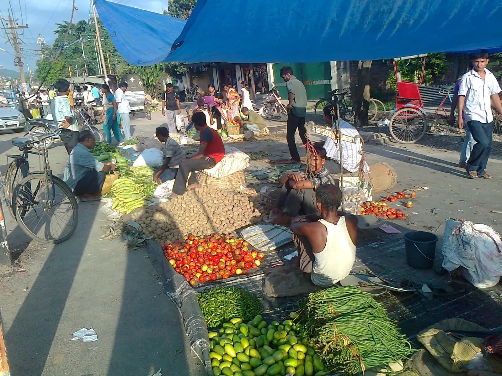 Vendors selling vegetables and produce along the roadside at Beltola Market in Guwahati