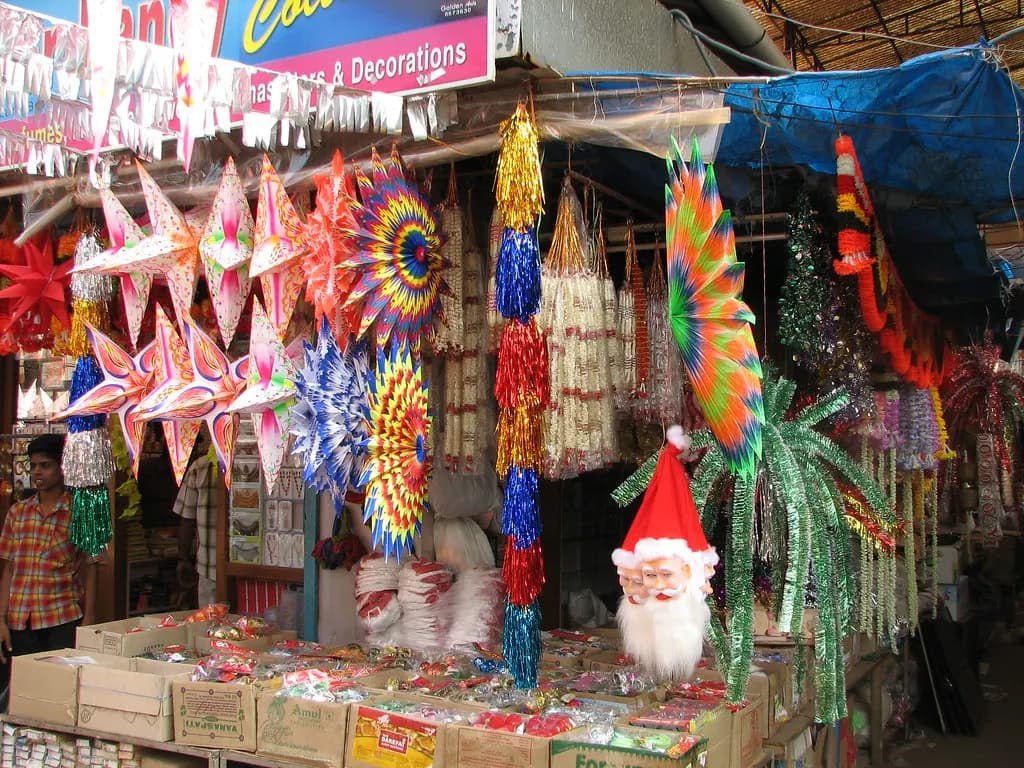 A Kochi shop crowded with paper Christmas stars, tinsel and Santa masks hanging from its front