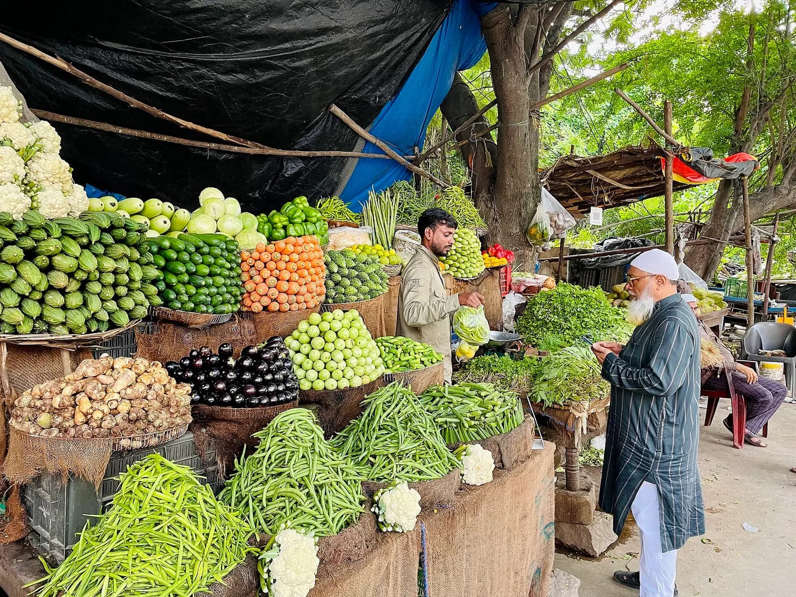 A roadside vegetable shop at Tolichowki, Hyderabad, with produce stacked in baskets