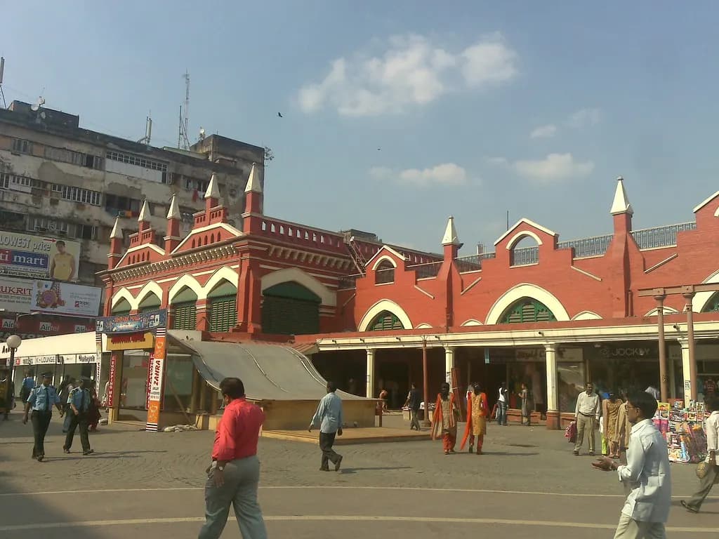 The red-brick clock-tower facade of New Market in central Kolkata with shoppers in front