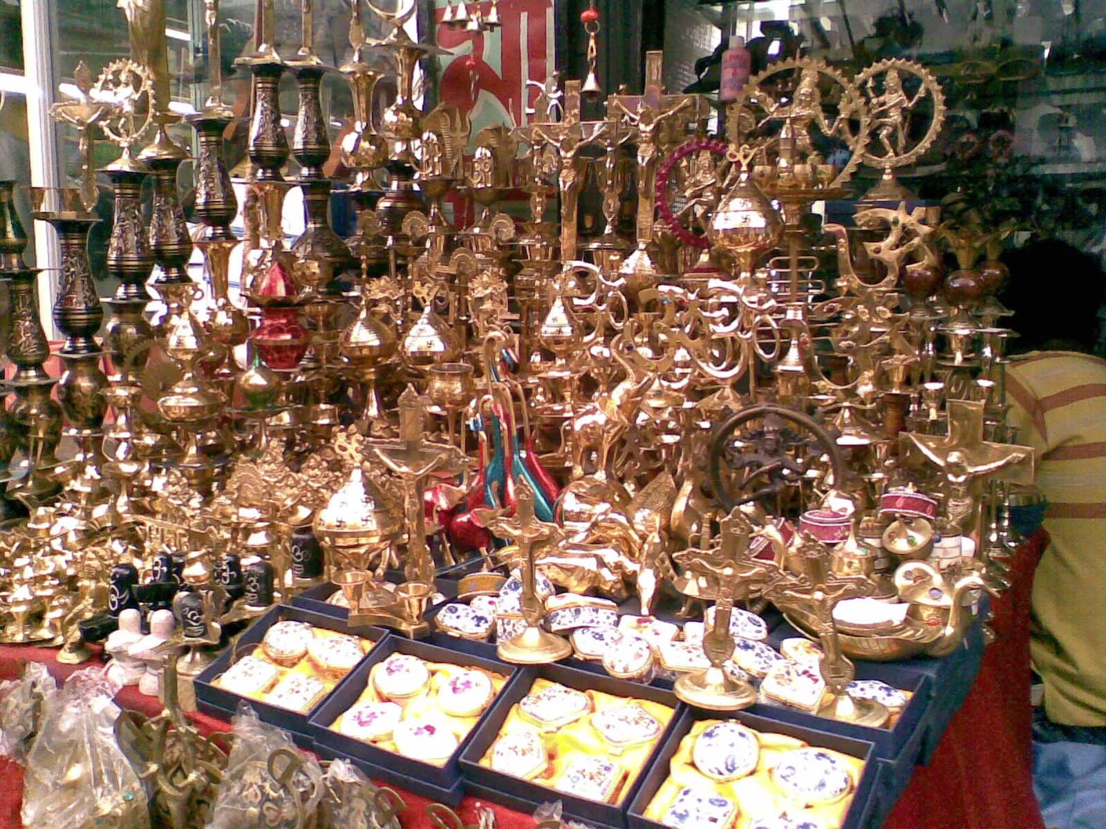 A market stall in Siliguri stacked with brass lamps, idols and decorative items