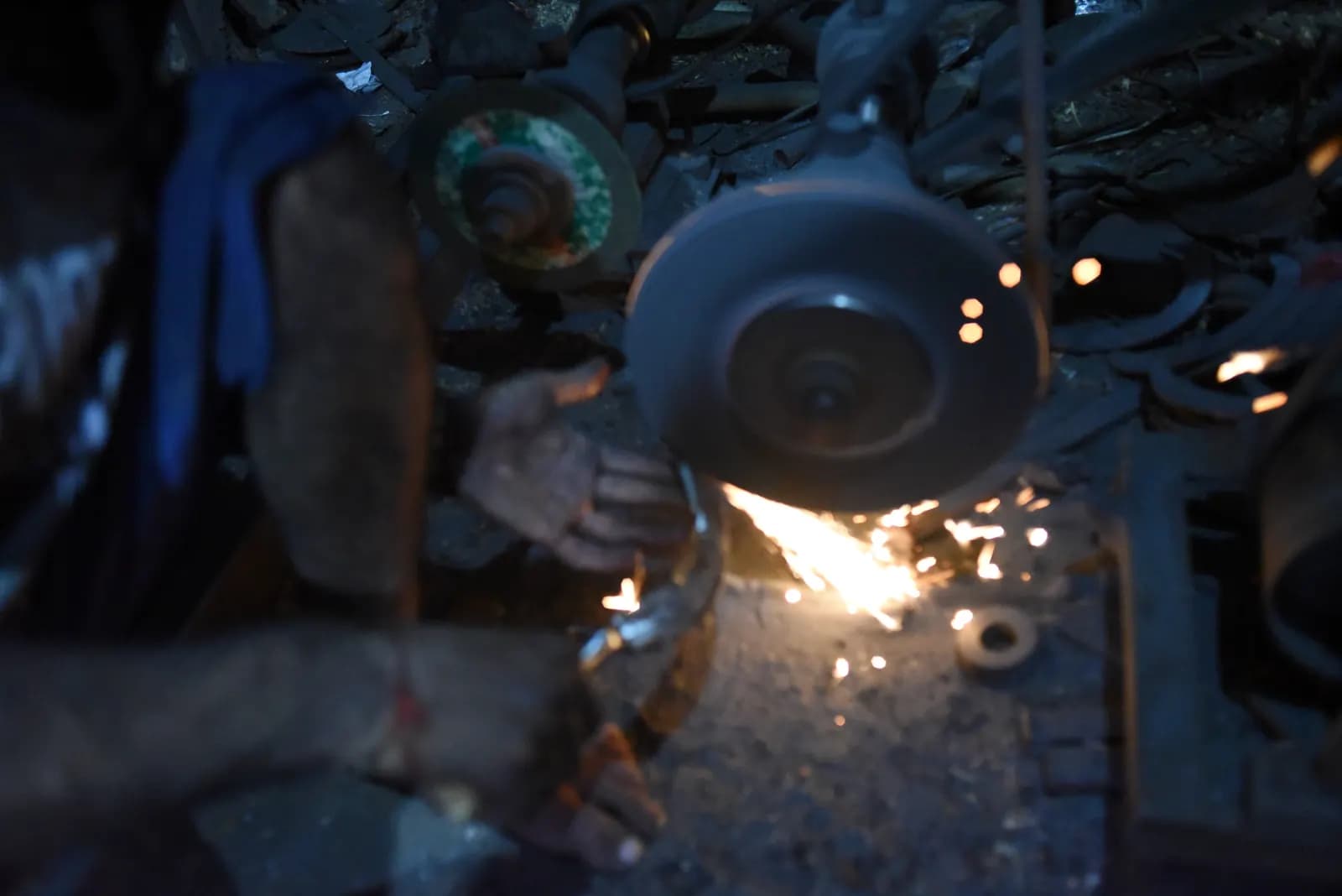 A village blacksmith in Rahon, Punjab, shaping hot iron at his forge