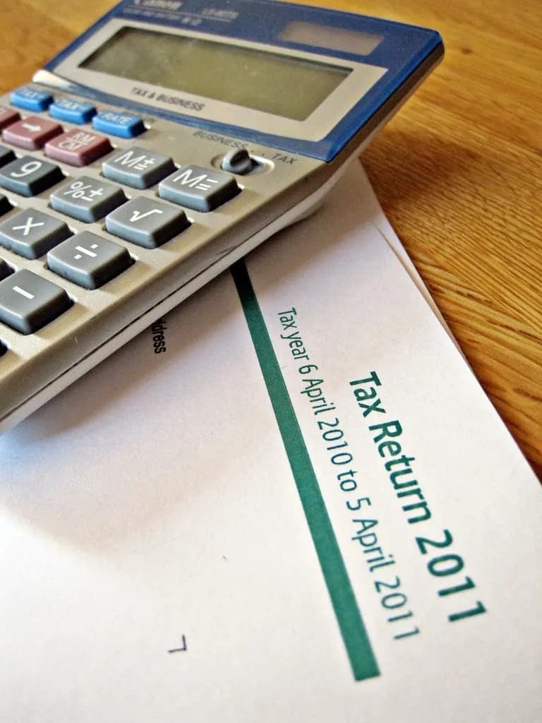 A calculator resting on printed tax paperwork