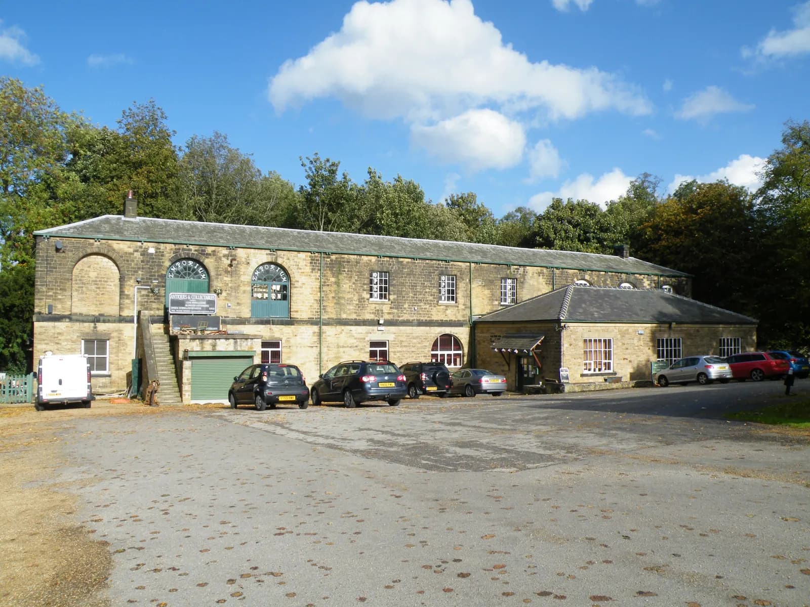 Two-storey stone joinery workshop building with a car park in front, Wentworth, South Yorkshire