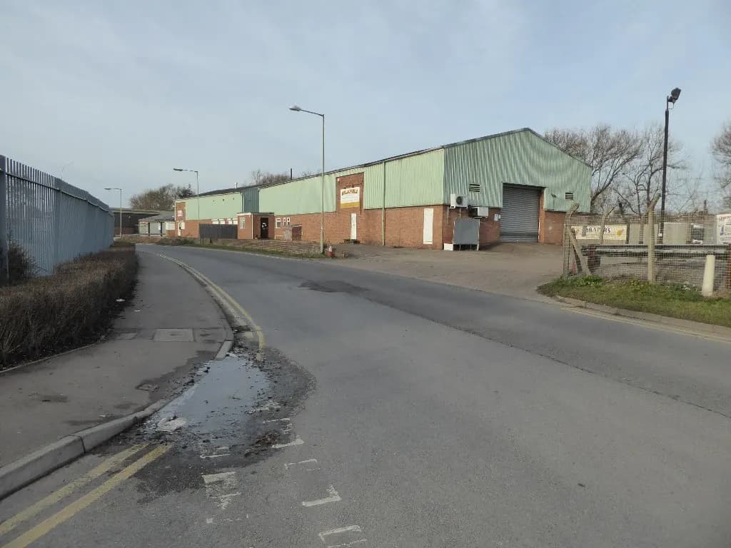 A light industrial building with roller shutter doors on a small business estate