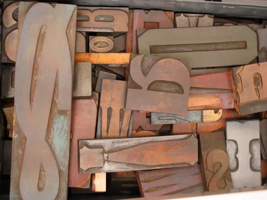 A drawer of old wooden letterpress type blocks of different sizes and styles