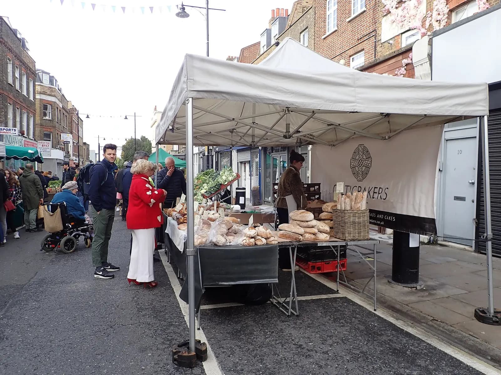 A sole trader's fresh bread stall at Islington Farmers' Market in London, with loaves laid out on the counter