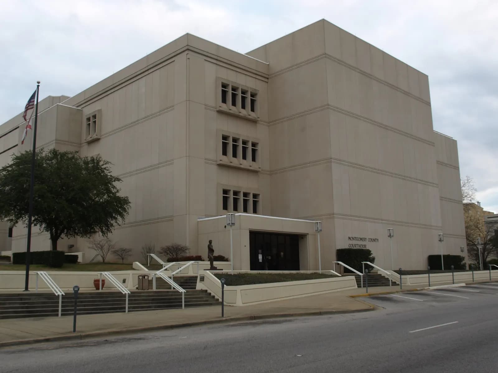 The Montgomery County Courthouse in Montgomery, Alabama, a pale stone-clad multi-storey building with steps and ramps leading to the entrance