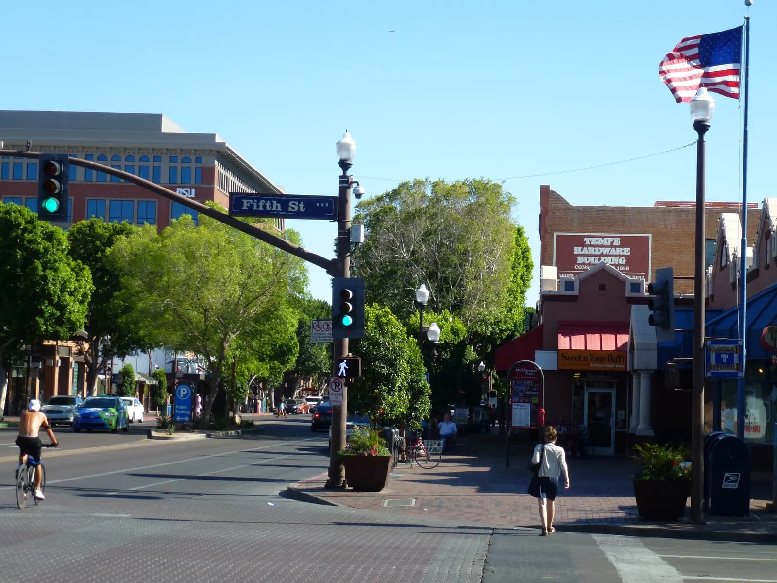 Mill Avenue at Fifth Street in Tempe, Arizona, with historic brick storefronts and a shaded sidewalk