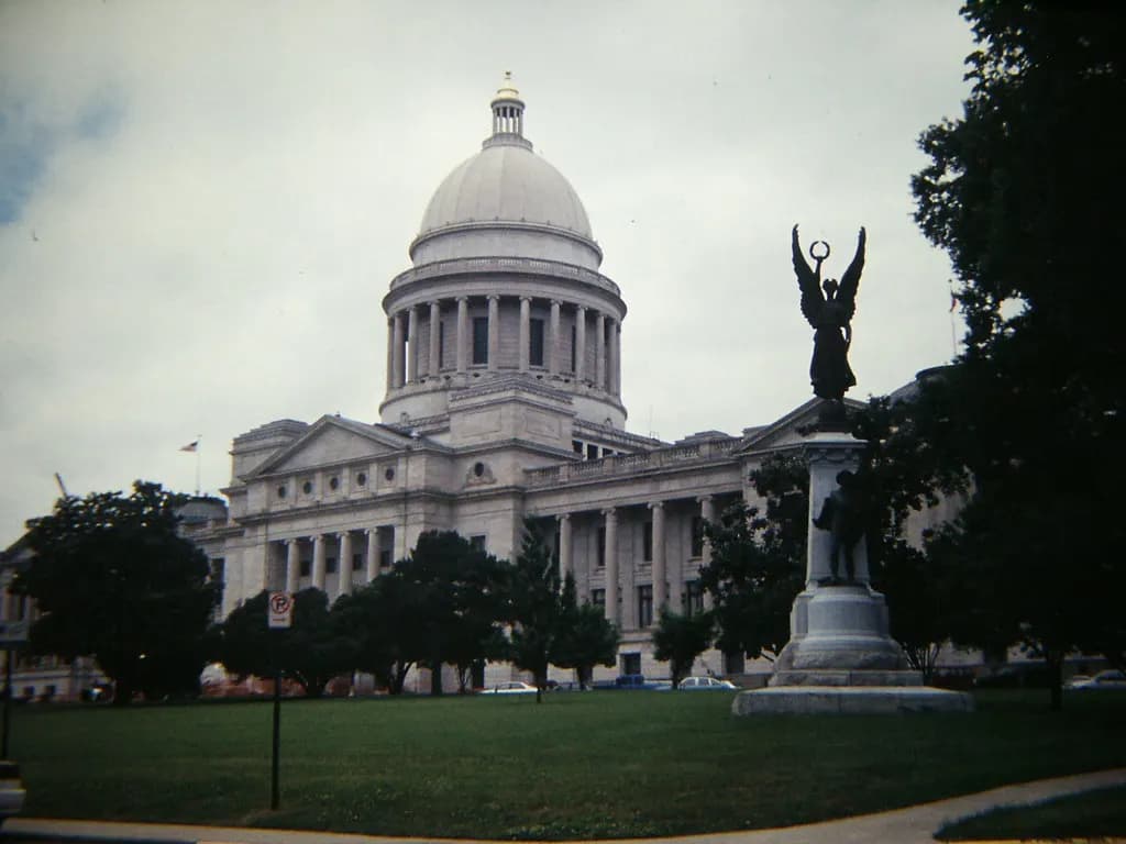The Arkansas State Capitol building in Little Rock under a blue sky