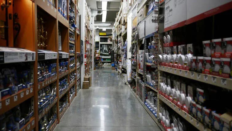 Long aisle of a hardware store with shelves of tools and supplies