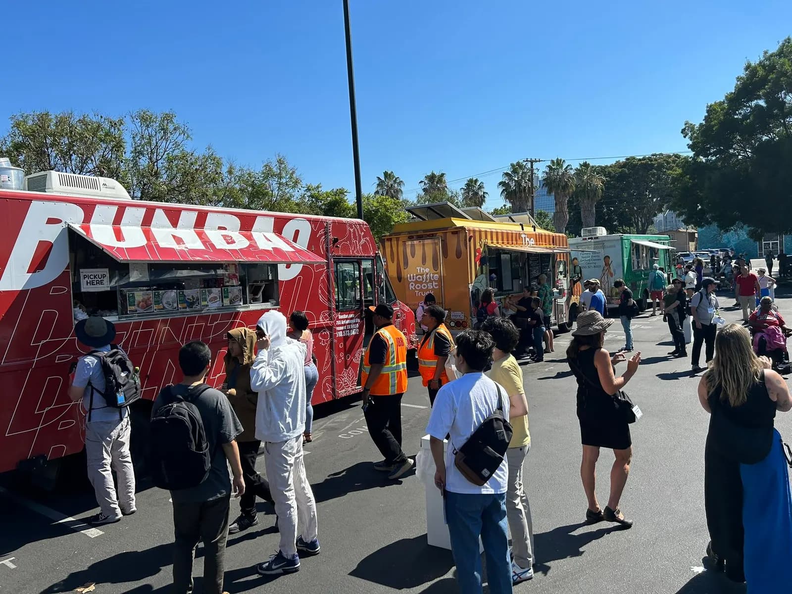 Food trucks parked side by side serving customers at an event in San Jose, California