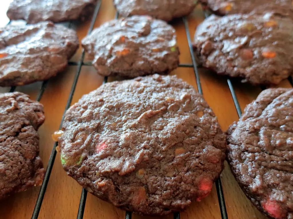 Homemade double chocolate chip cookies cooling on a wire rack