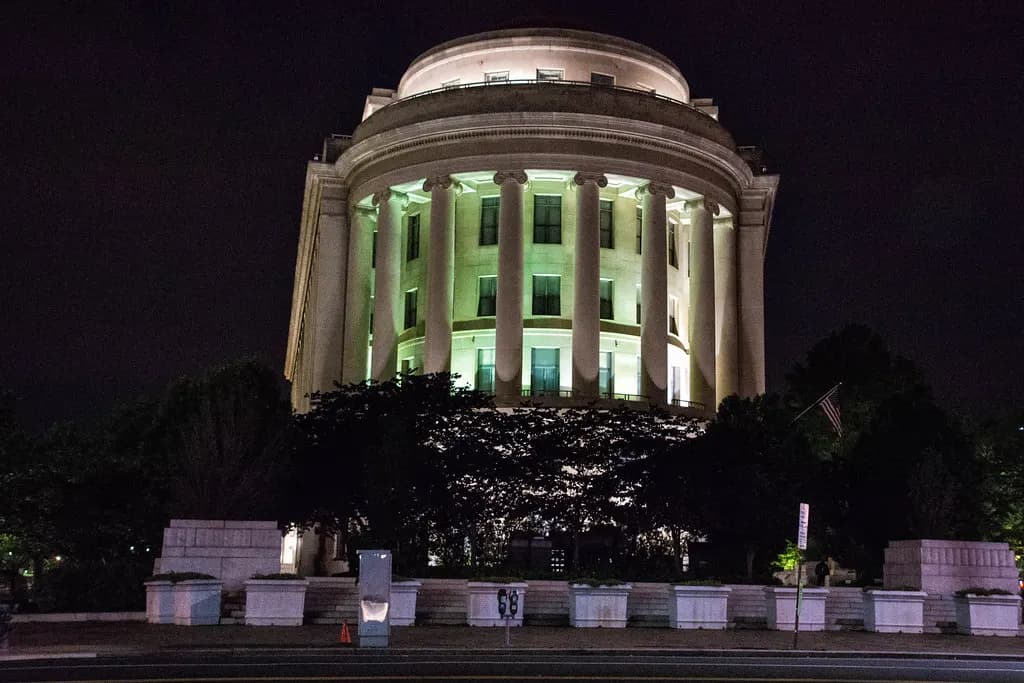 Rounded colonnaded end of the Federal Trade Commission building in Washington, DC, lit at night