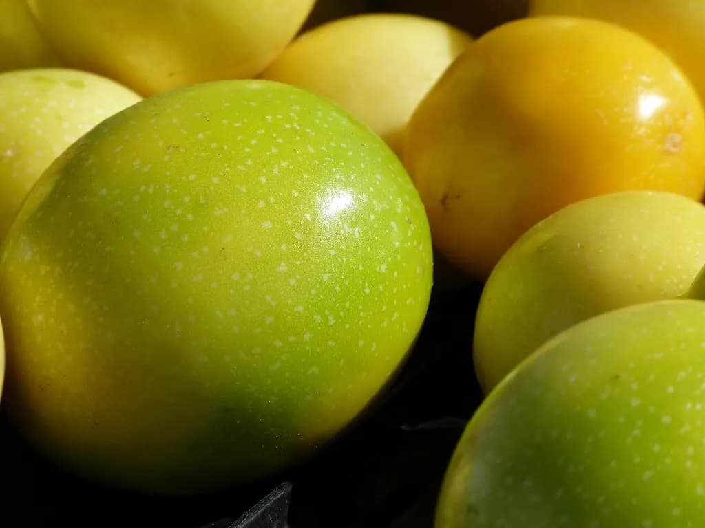 Yellow and green passion fruit for sale at the Kula farmers market on Maui
