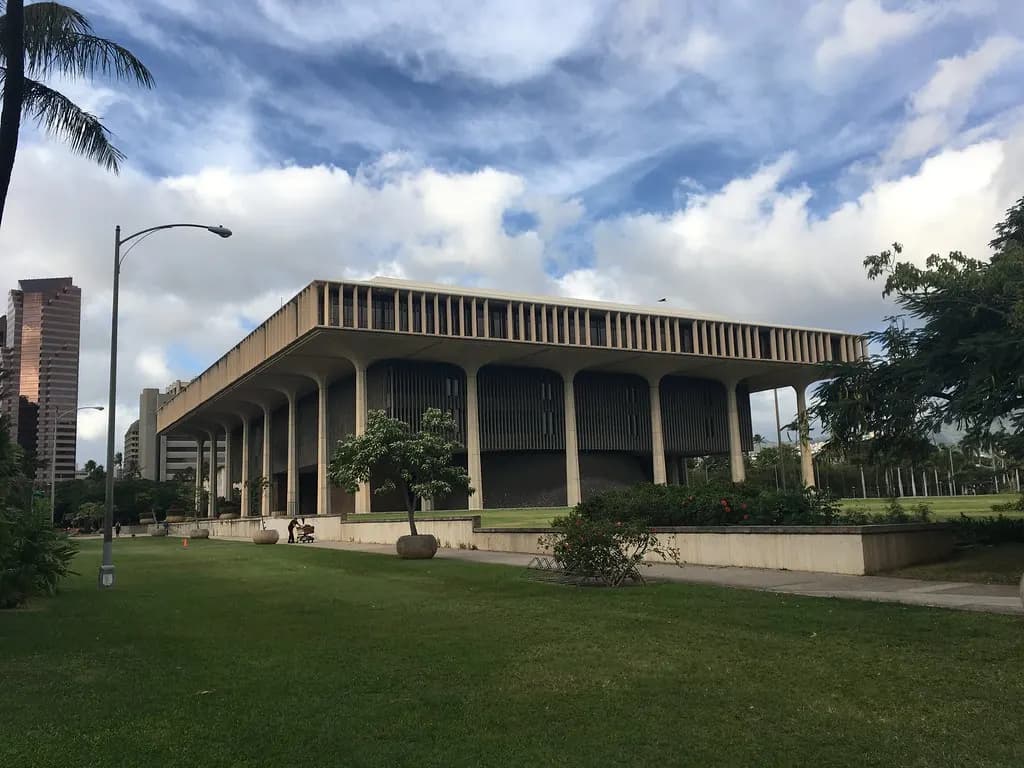 The Hawaii State Capitol in Honolulu under a cloudy sky