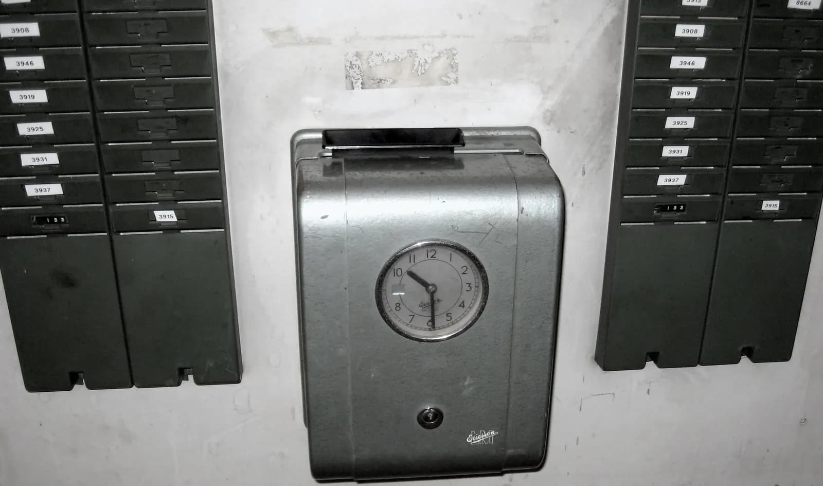 Mechanical time recorder clock used to stamp employees' start and finish times on time cards
