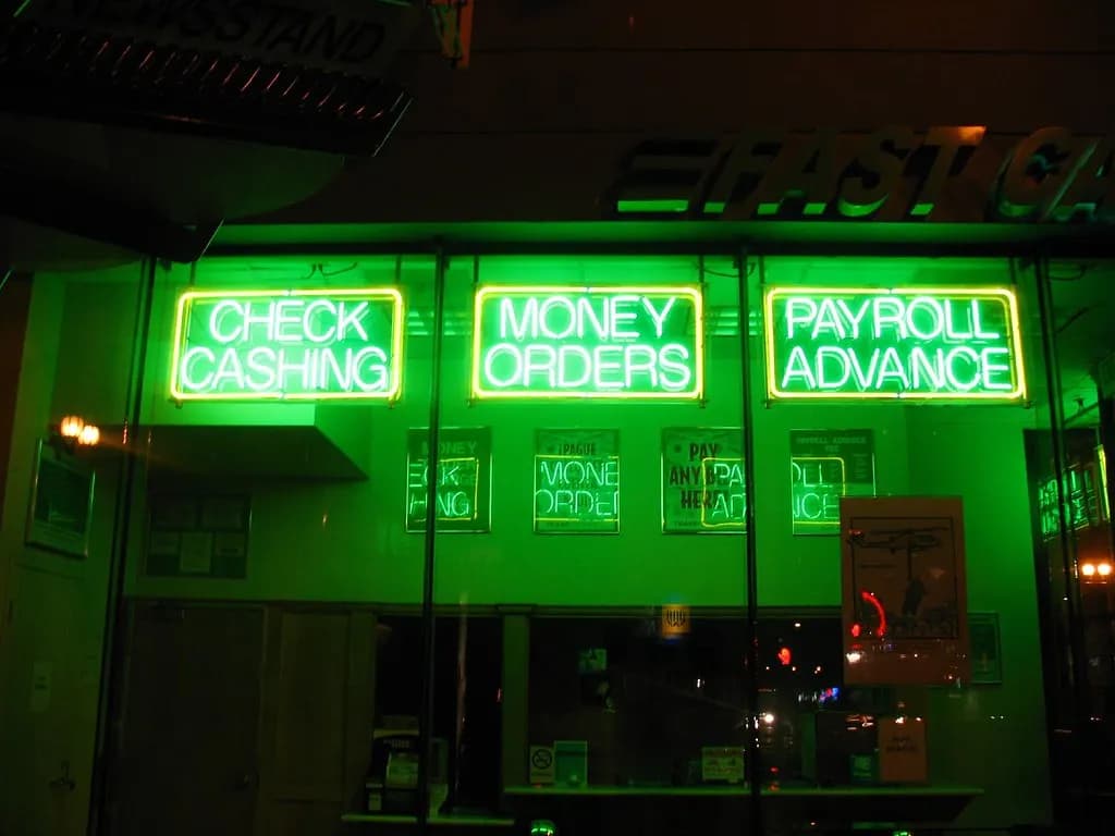 A payroll check and cash on a table