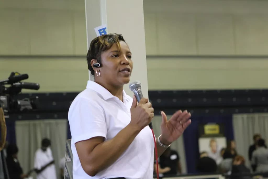 An organizer speaks into a microphone at a career expo in Marietta, Georgia