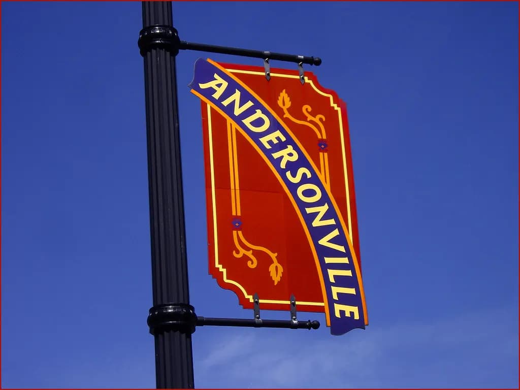 Andersonville neighborhood street banner on a lamppost against a blue sky on Chicago's North Side