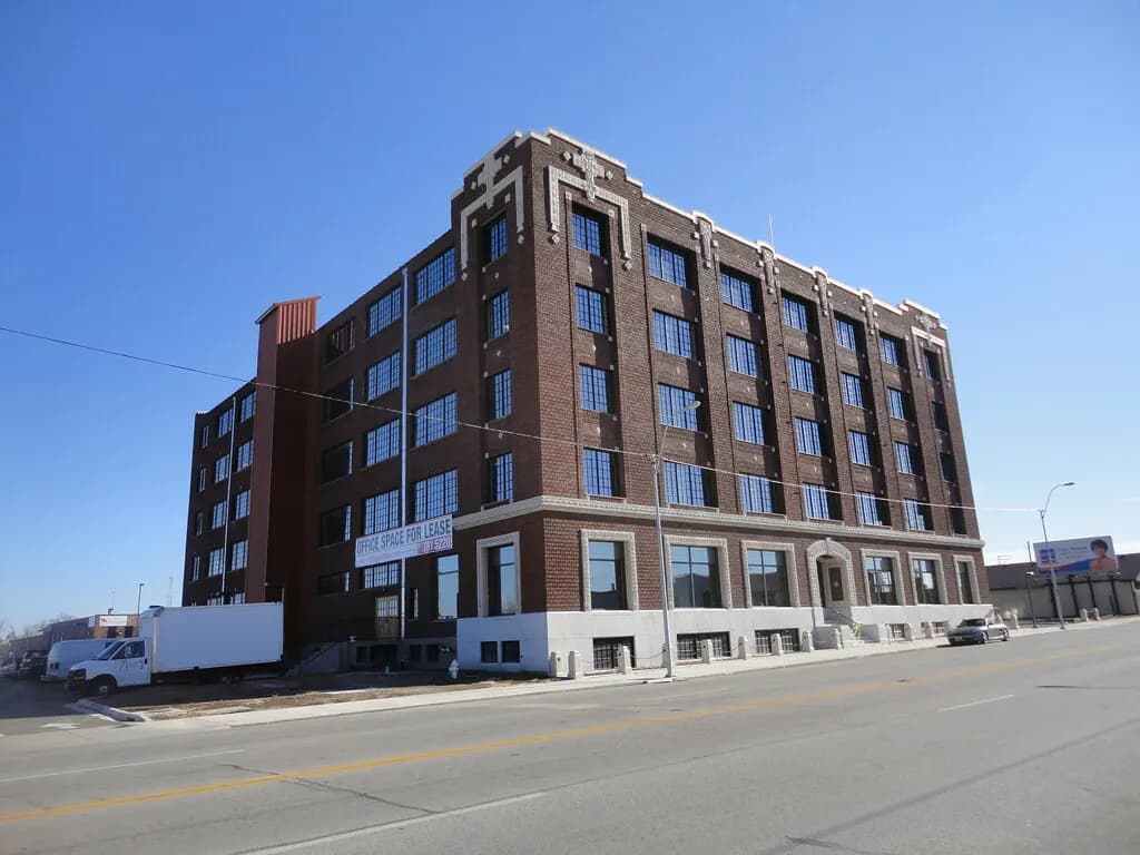 Five-storey brick office building with an office space for lease banner above the ground floor in Joplin, Missouri