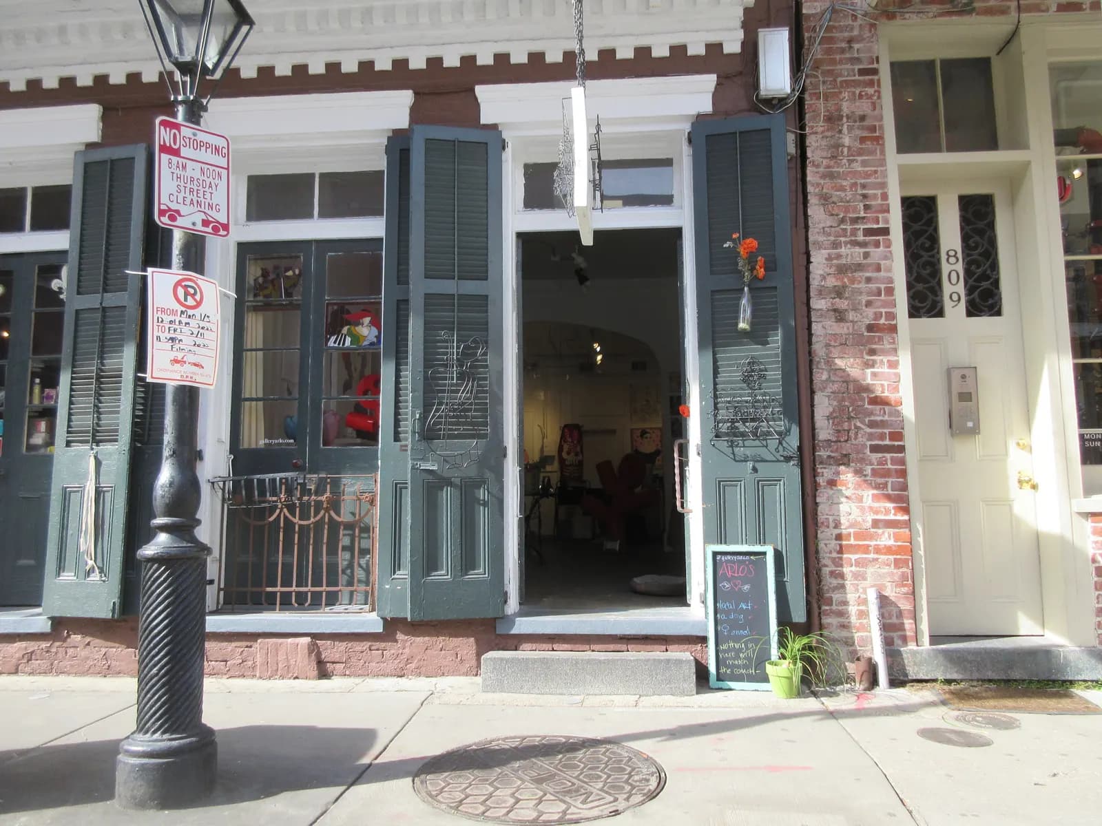 Open shop doorway with green shutters on Royal Street in the French Quarter of New Orleans