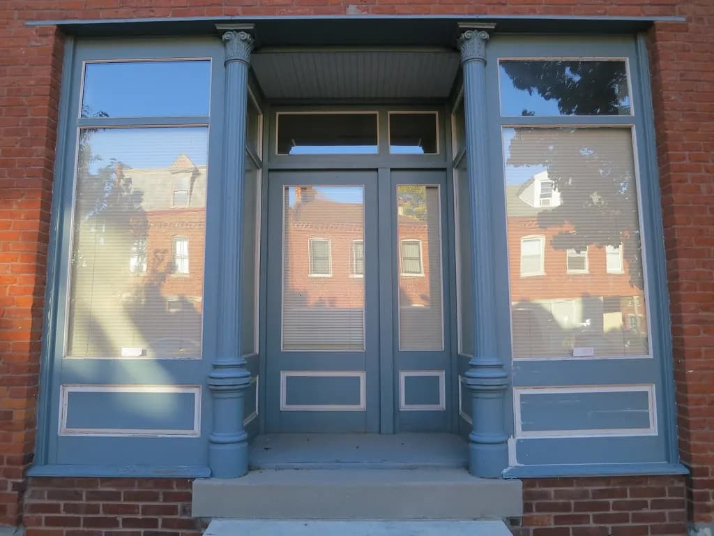 A small brick storefront with cast iron columns in St. Louis