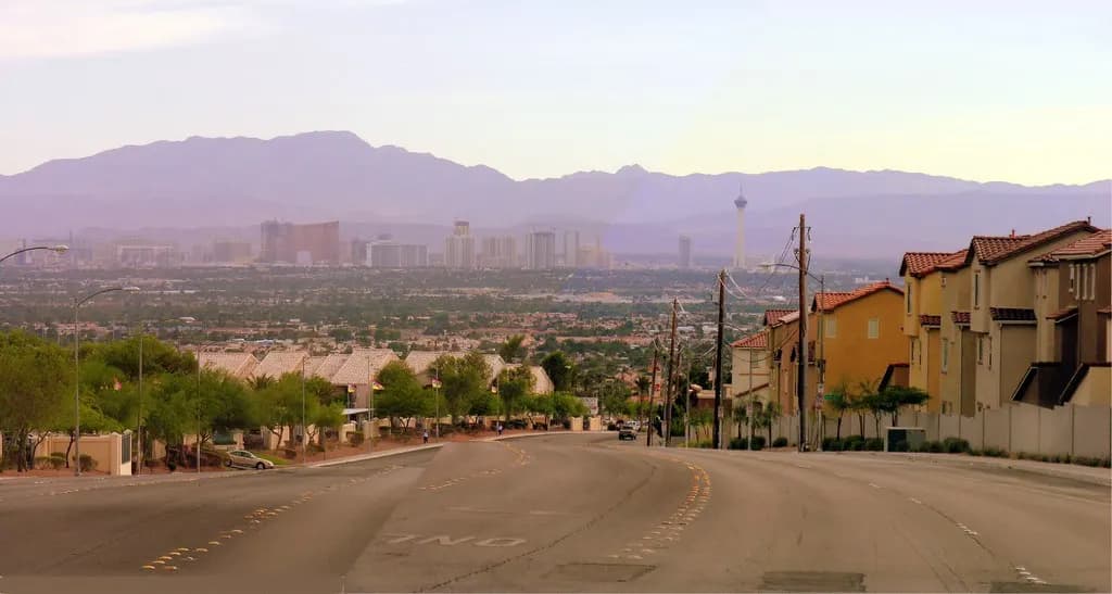 Suburban streets in the Las Vegas Valley with the Strip skyline and mountains in the distance