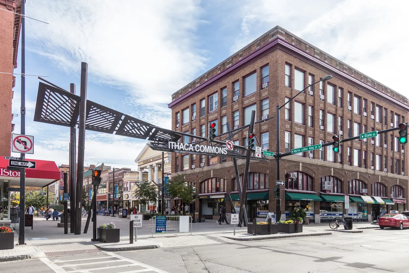 The entrance arch to the Ithaca Commons pedestrian shopping street, with brick storefronts with green awnings