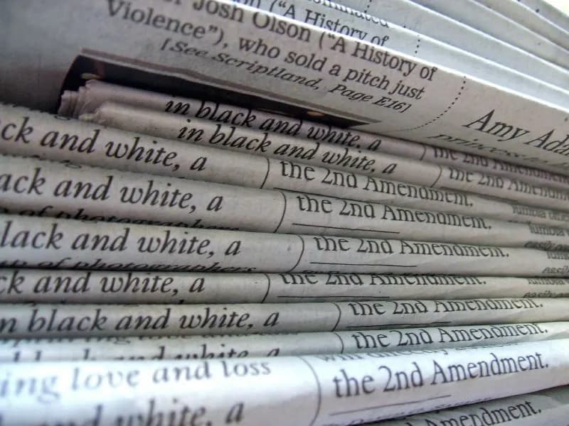 A folded stack of printed newspapers