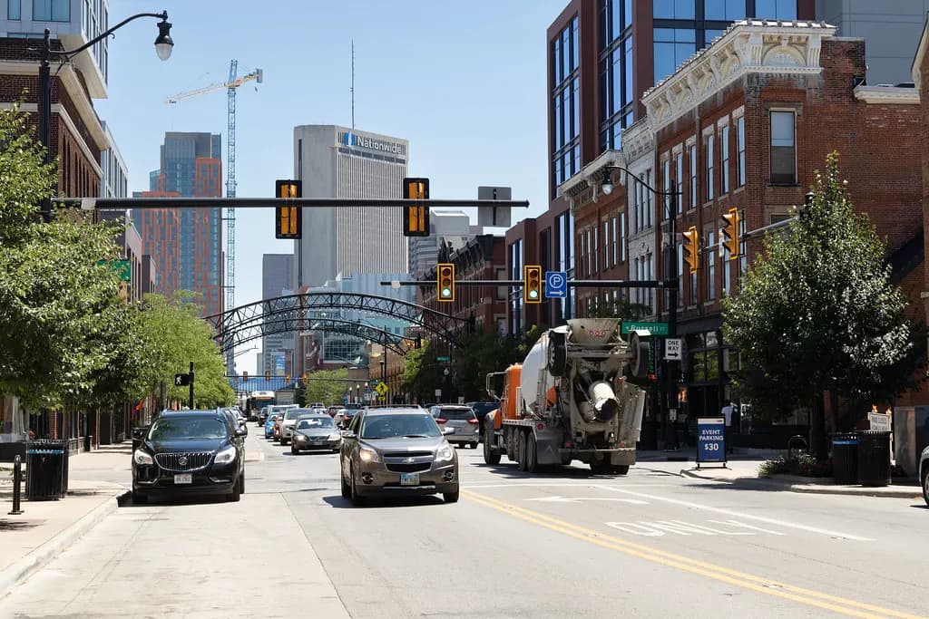 High Street in the Short North district of Columbus, Ohio, lined with brick shops and restaurants under the neighborhood's lighted arches