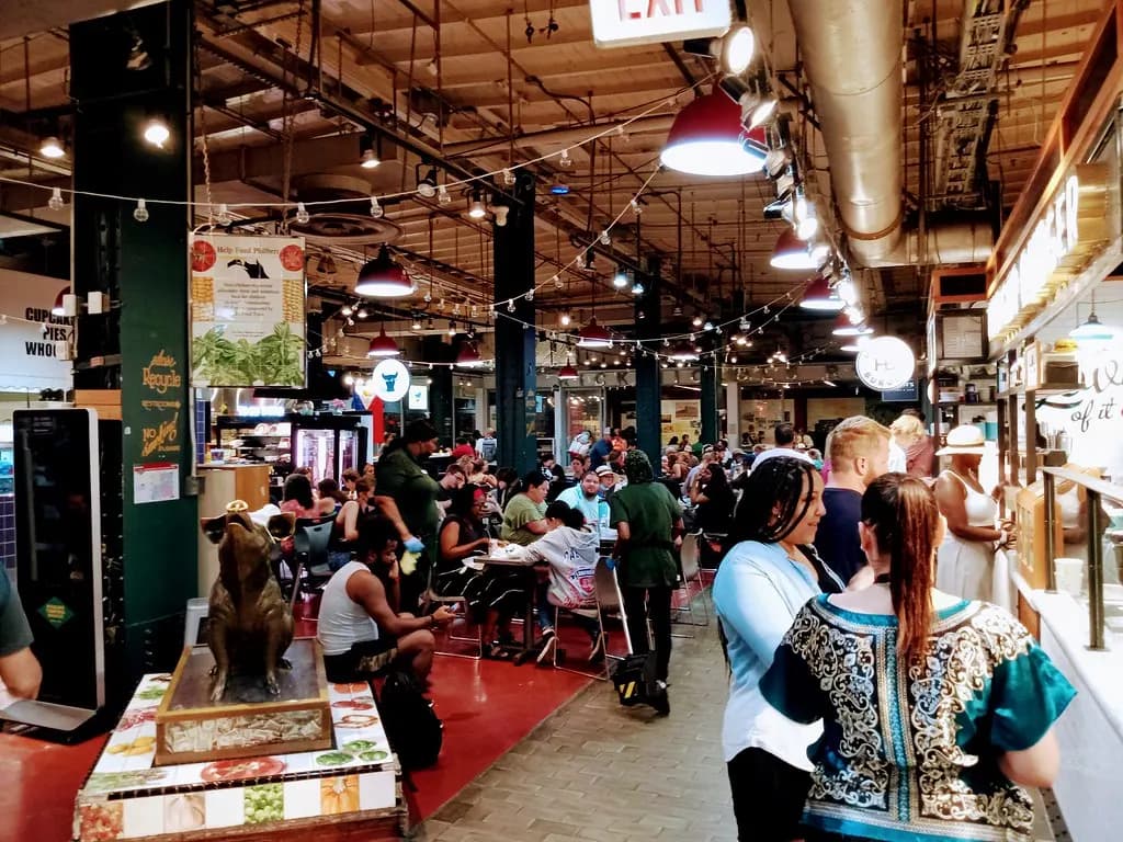 Lunchtime crowds at food stalls and tables inside Reading Terminal Market in Philadelphia