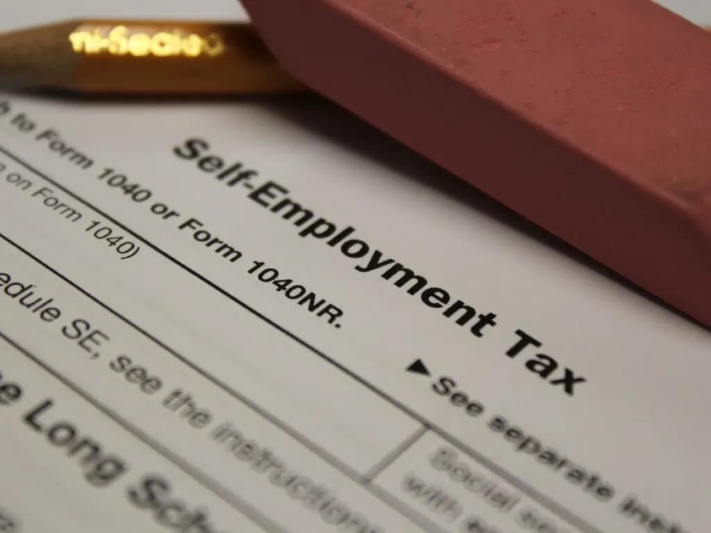 IRS Schedule SE self-employment tax form on a desk