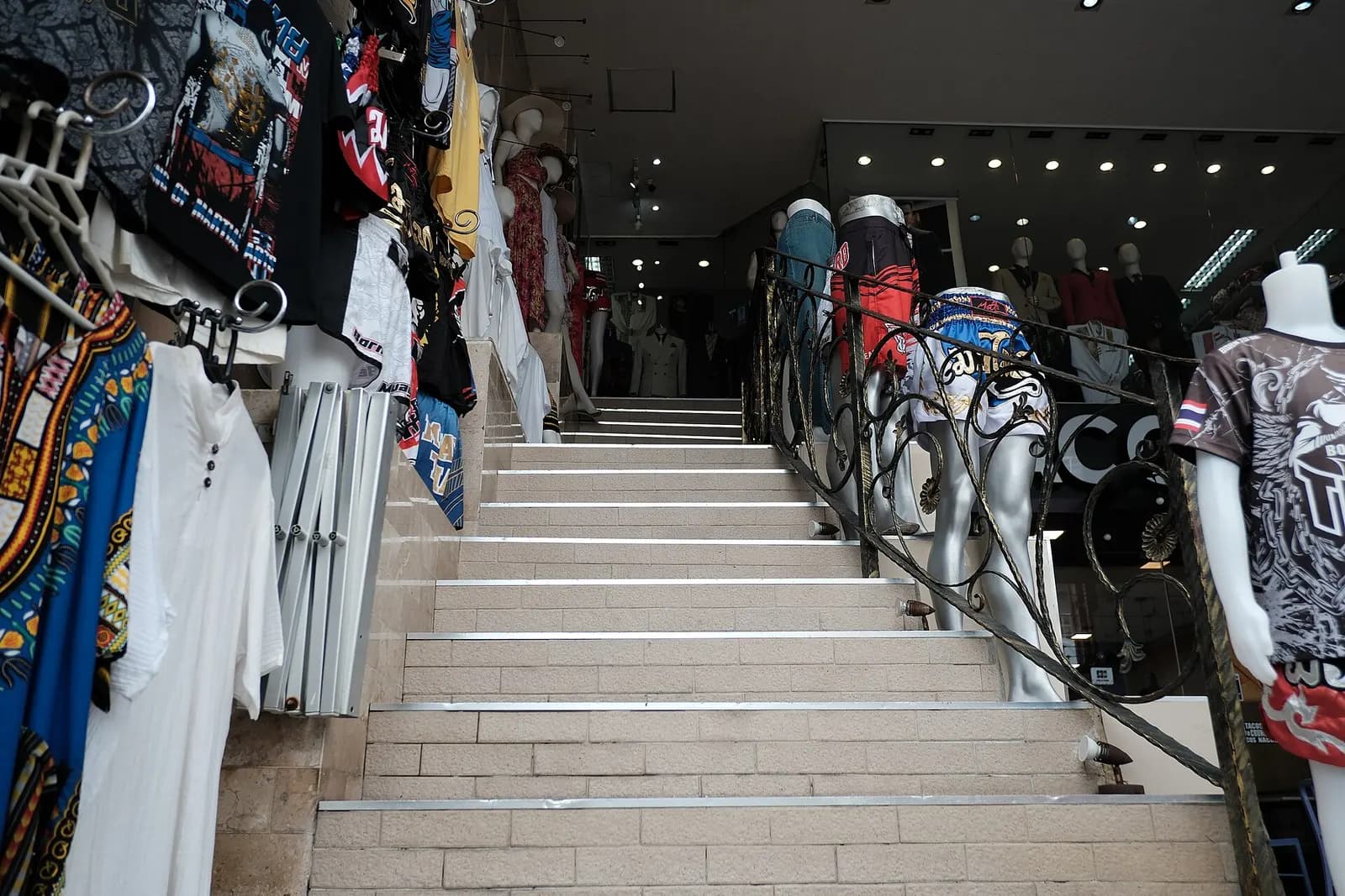 Mannequins and racks of colourful clothing at the entrance to a small boutique
