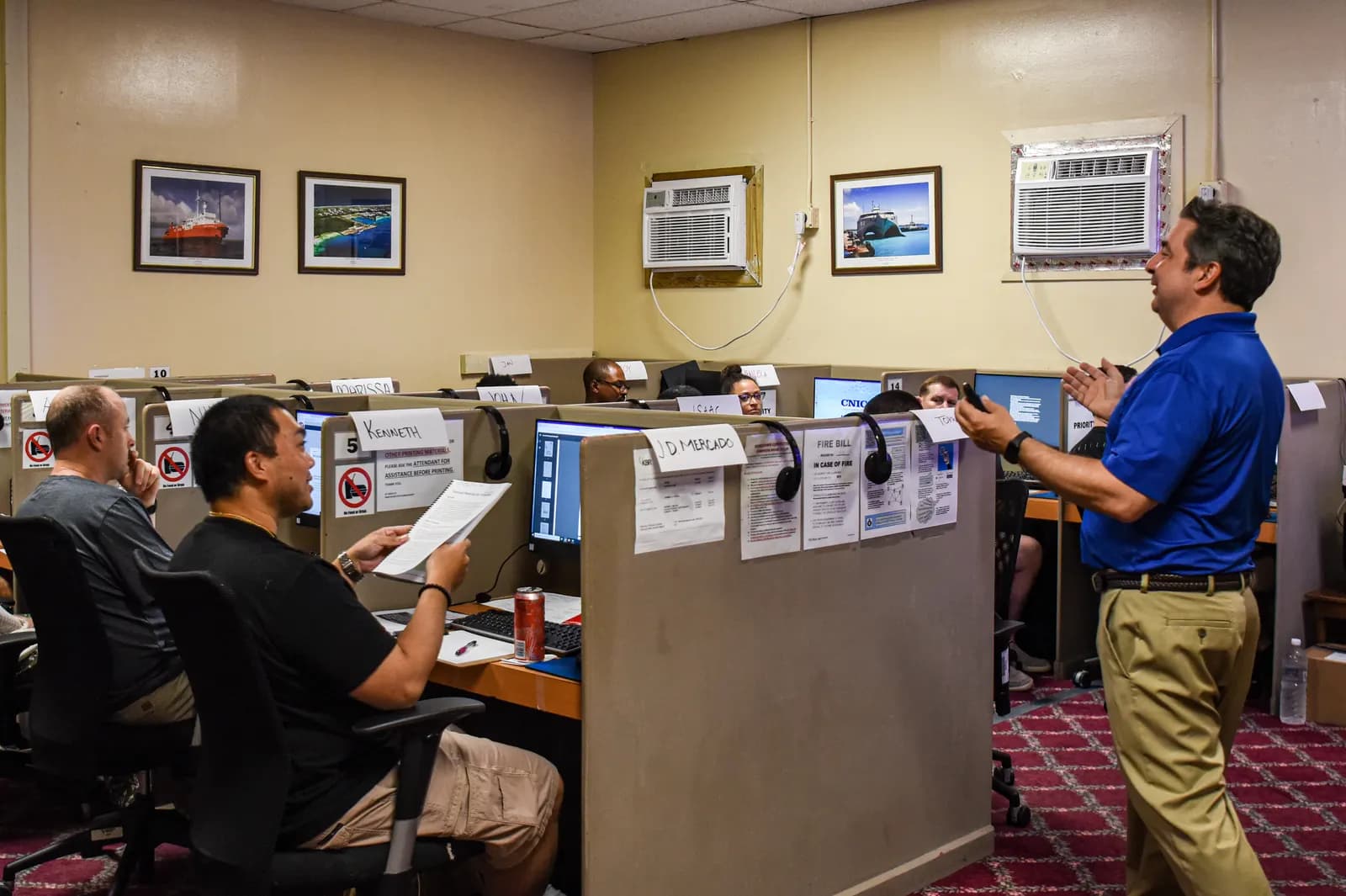 Service members at computer workstations listening to an instructor during a Transition Assistance Program class