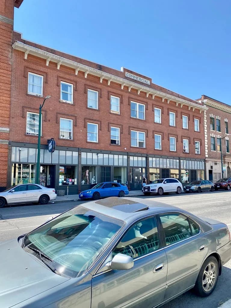 A historic brick commercial block with street-level shopfronts on 1st Avenue in Spokane, Washington