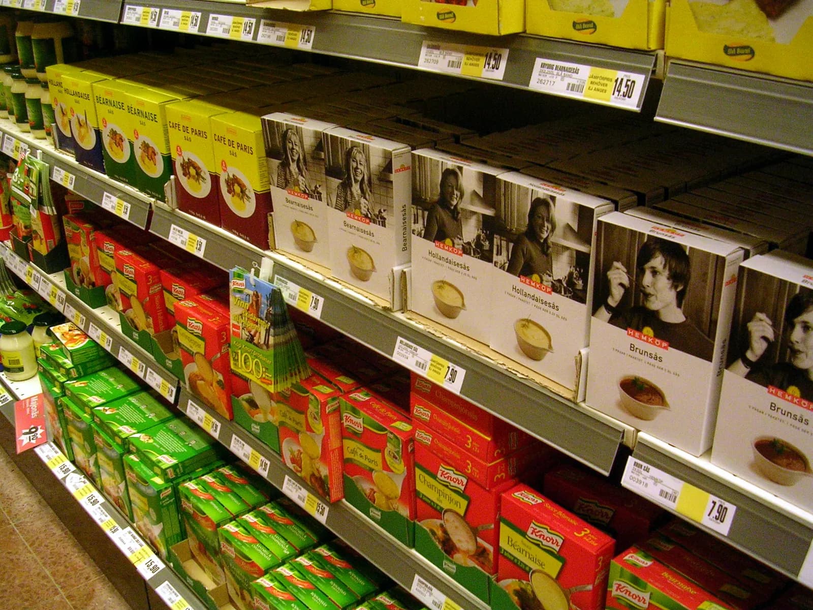 Supermarket shelves stocked with a retailer's own-brand packaged foods in matching packaging