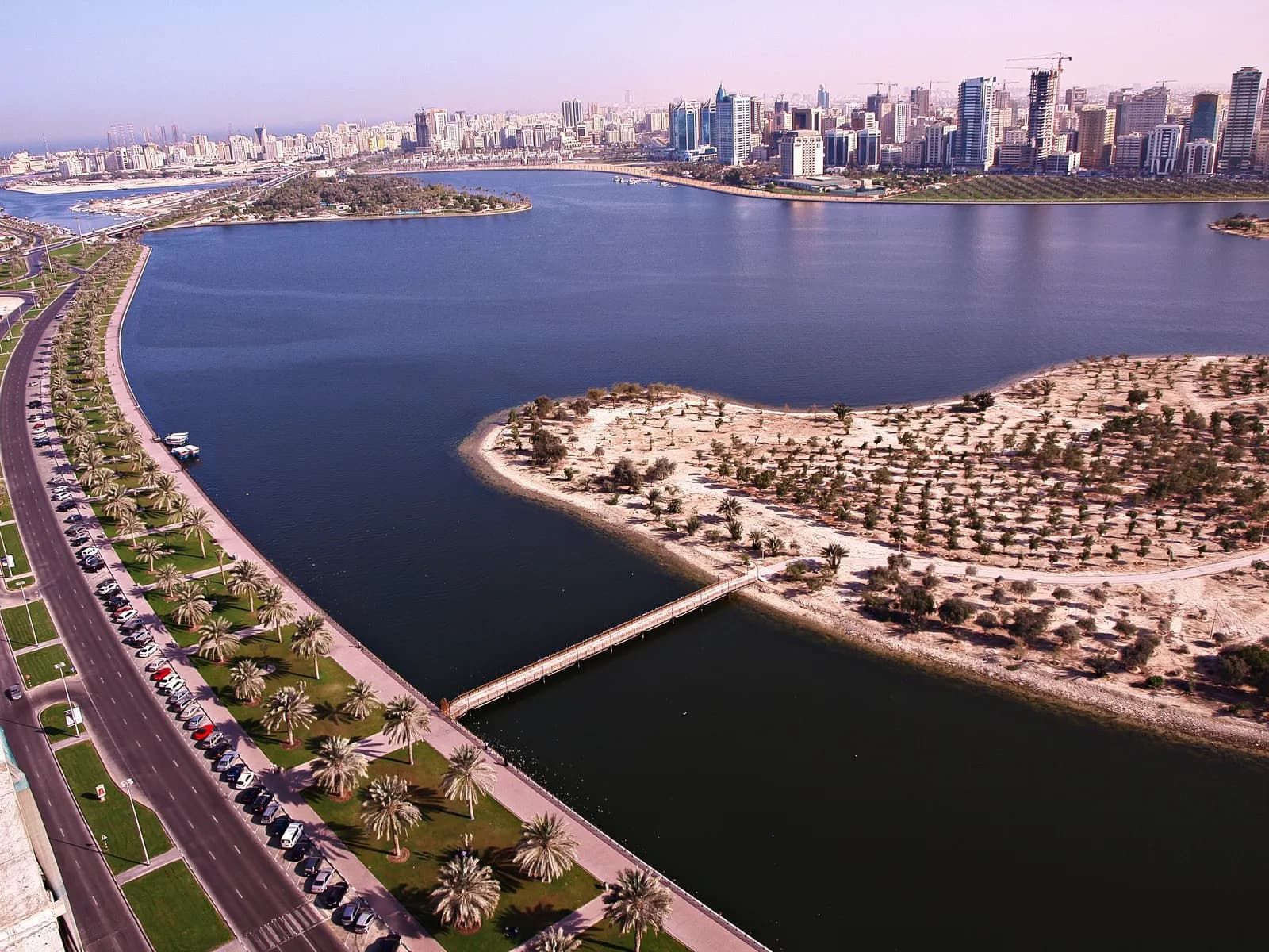 Sharjah's Buhairah Corniche with towers along the lagoon